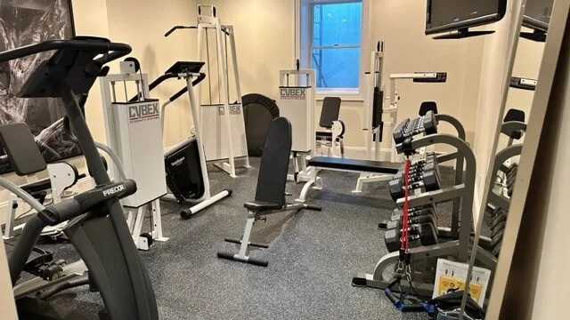 A gym with exercise machines and weight-training equipment.