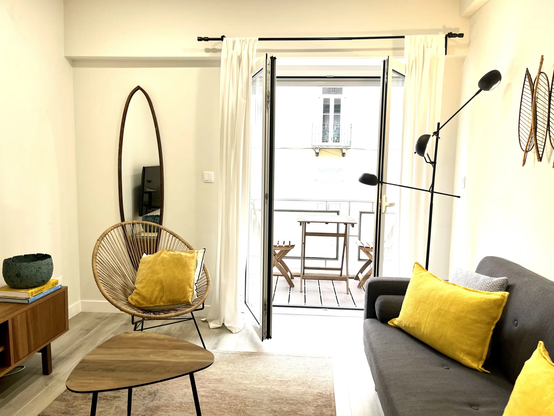 Living room with seating and an open balcony doorway.