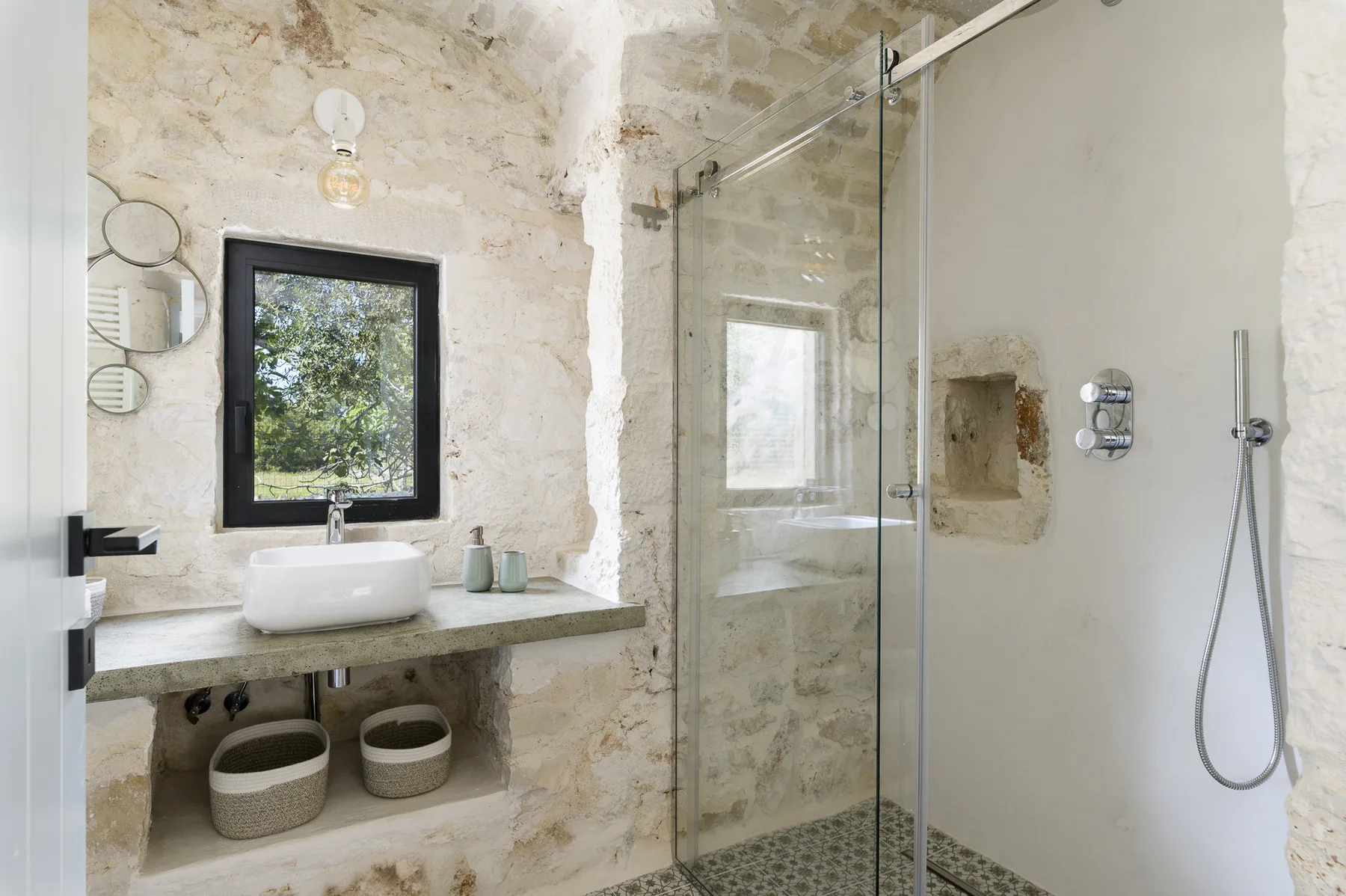 A bathroom with a sink beside a glass shower.