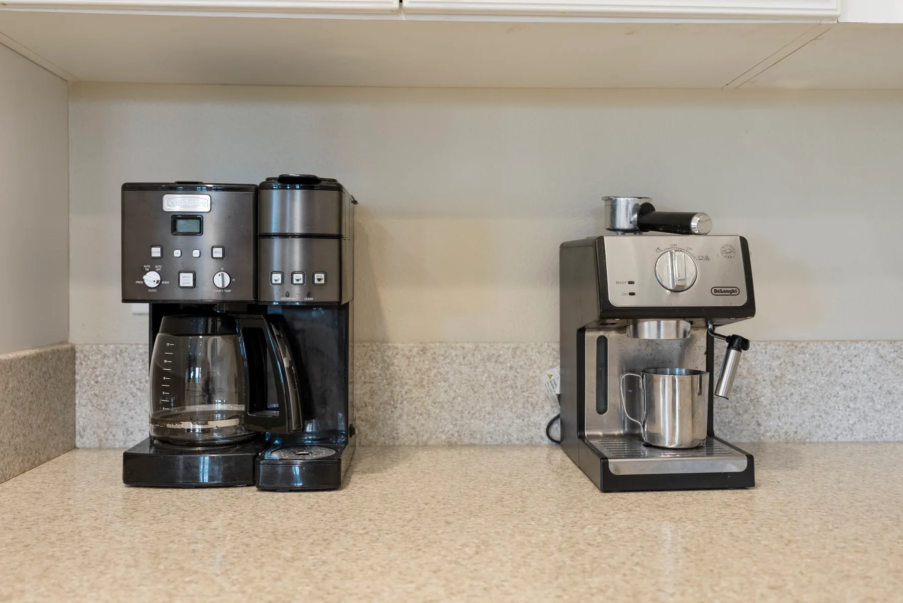 A countertop with a drip coffee maker and an espresso machine.