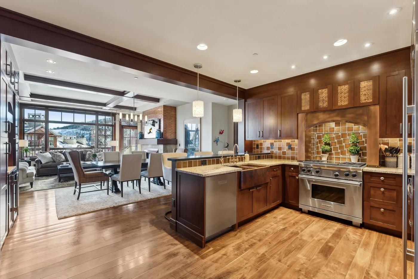 An open-plan kitchen and dining area with a central island and wood cabinetry.