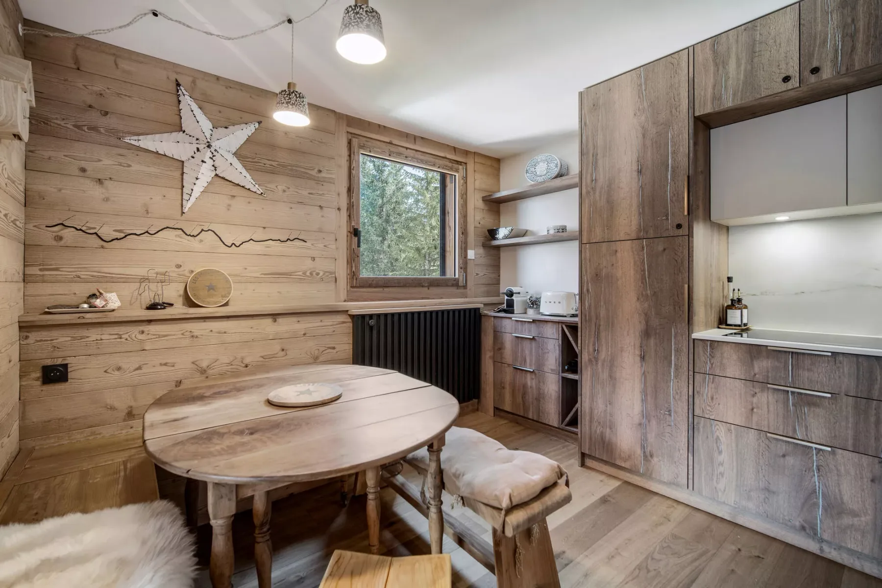 A wood-paneled dining area with a table beside built-in cabinets.