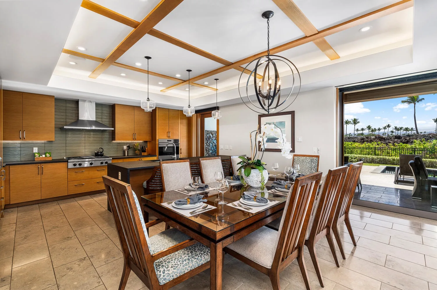 Comedor junto a una cocina abierta, con una mesa preparada para comer.