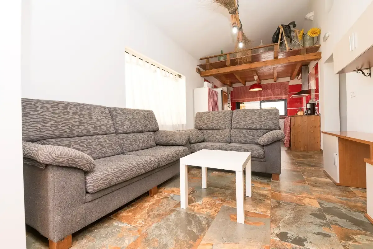 A living room with gray seating and a small white coffee table.