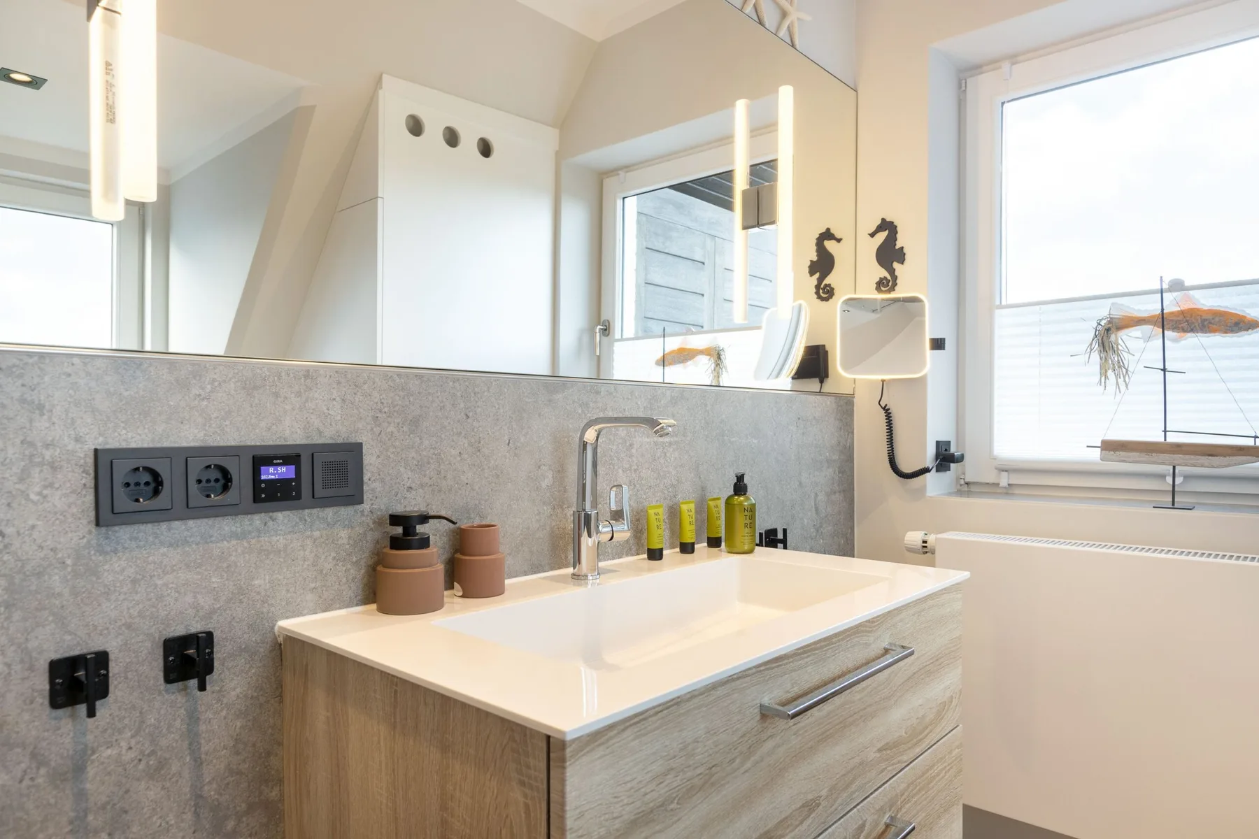 A bathroom vanity with a wide sink and a large window.