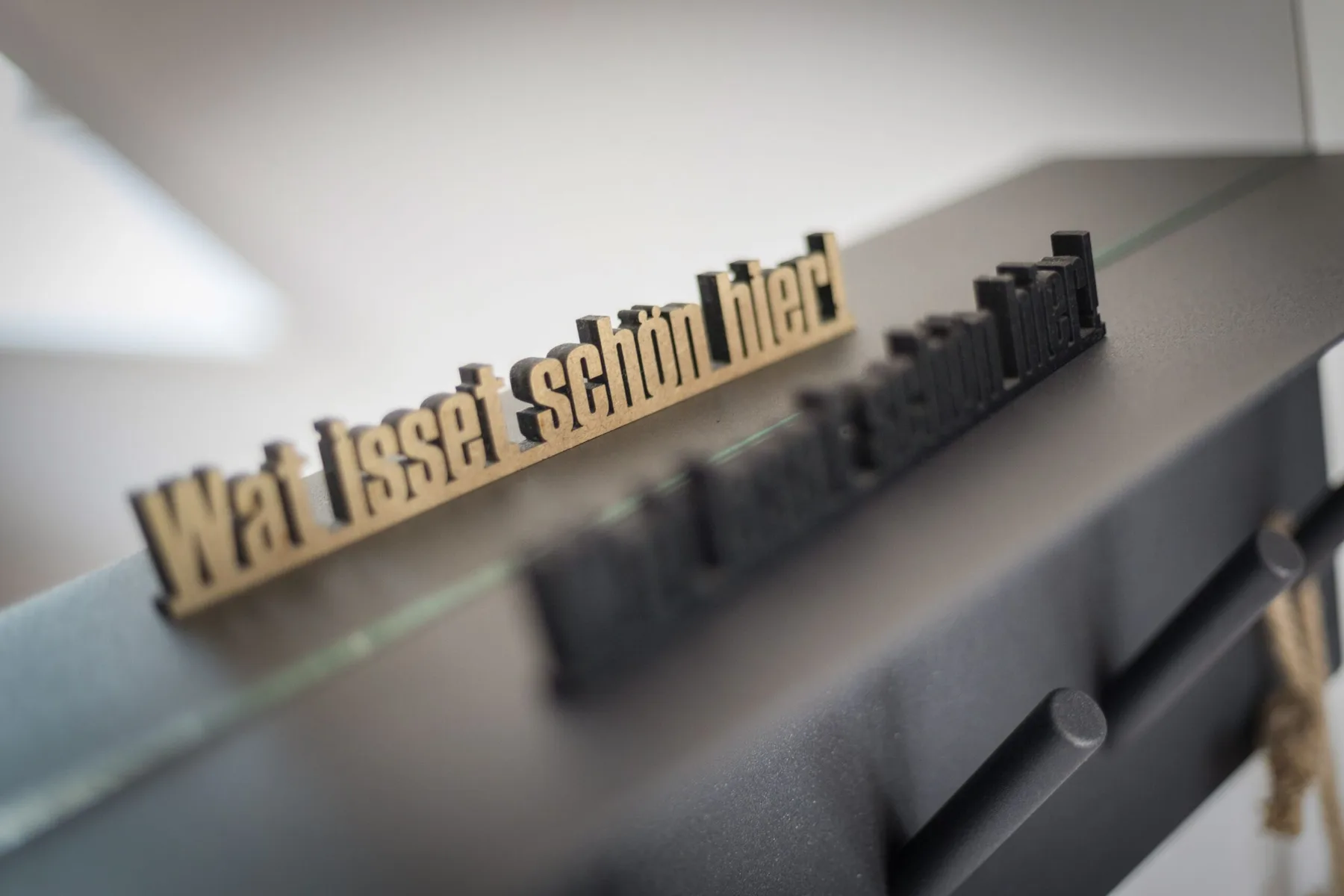 A close-up of raised lettering on a dark display surface.