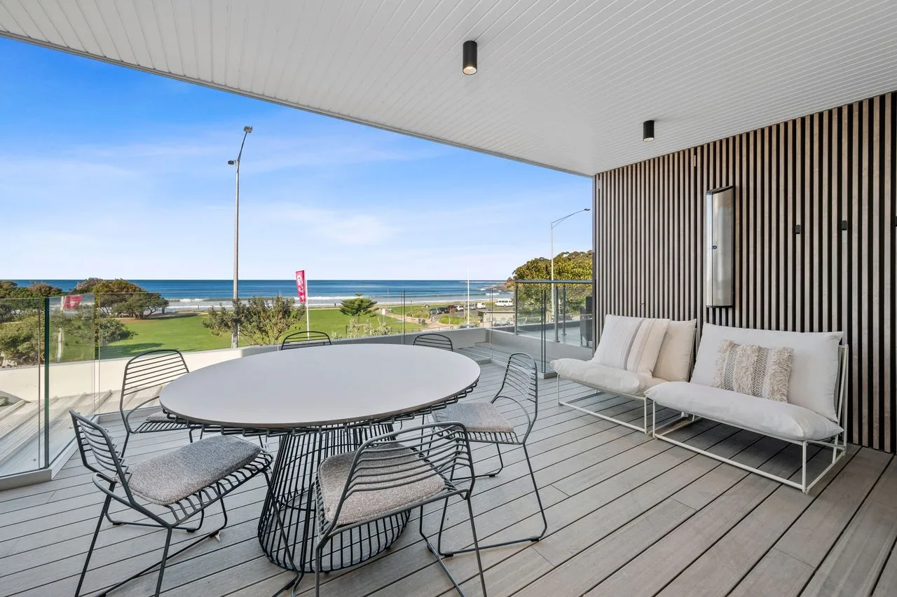 A covered outdoor seating area overlooks the ocean.