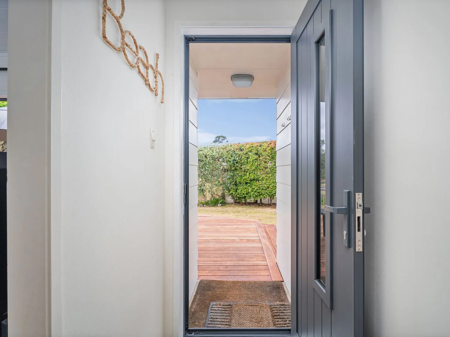 An entryway with a door leading to a garden at Slice of Pauanui - Pauanui