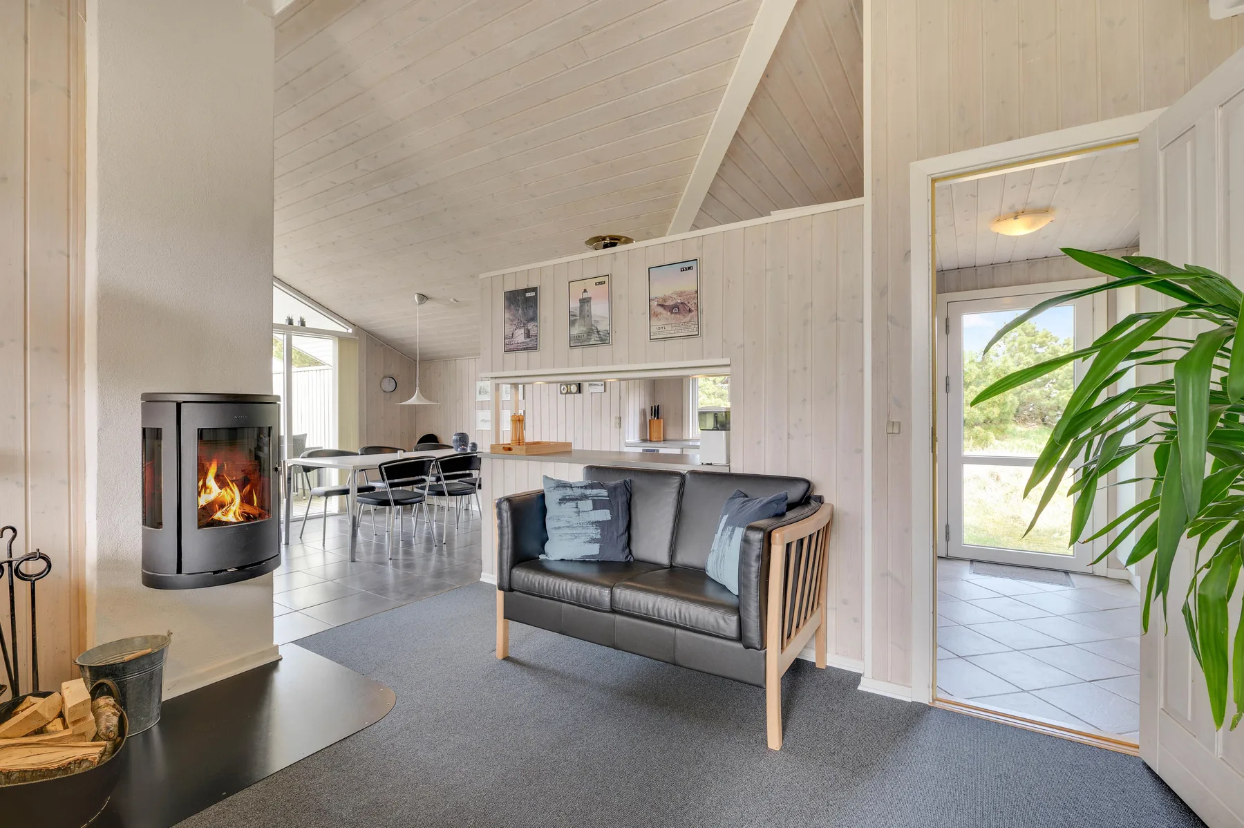 A bright living room with a seating area and a fireplace.