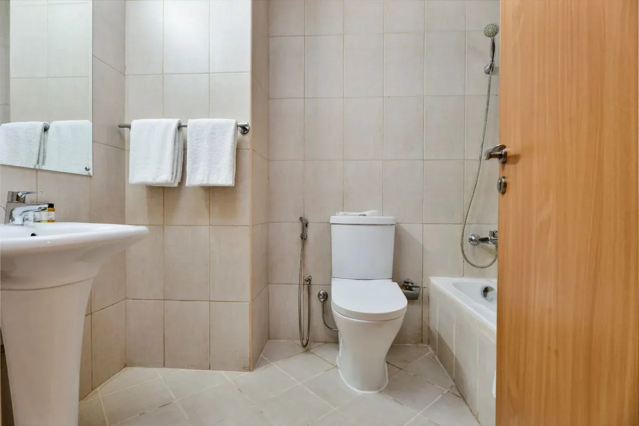 A tiled bathroom with a sink, toilet, and bathtub.