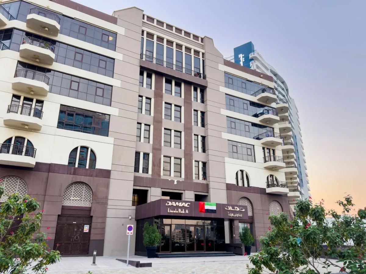 A multi-story commercial building with glass windows and storefronts at street level.