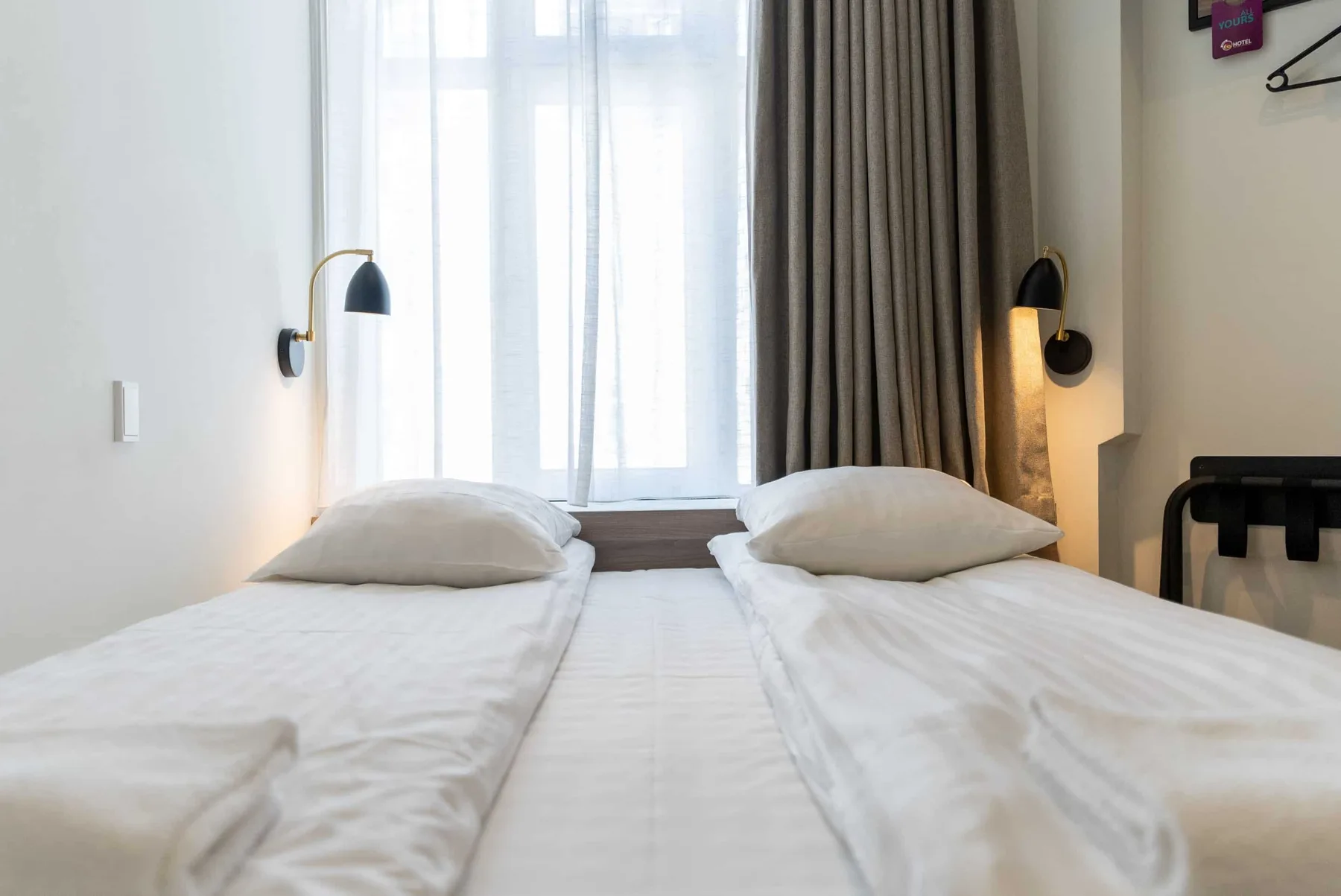 Double bed with bedside lamps in a Go Hotel Saga standard double room.