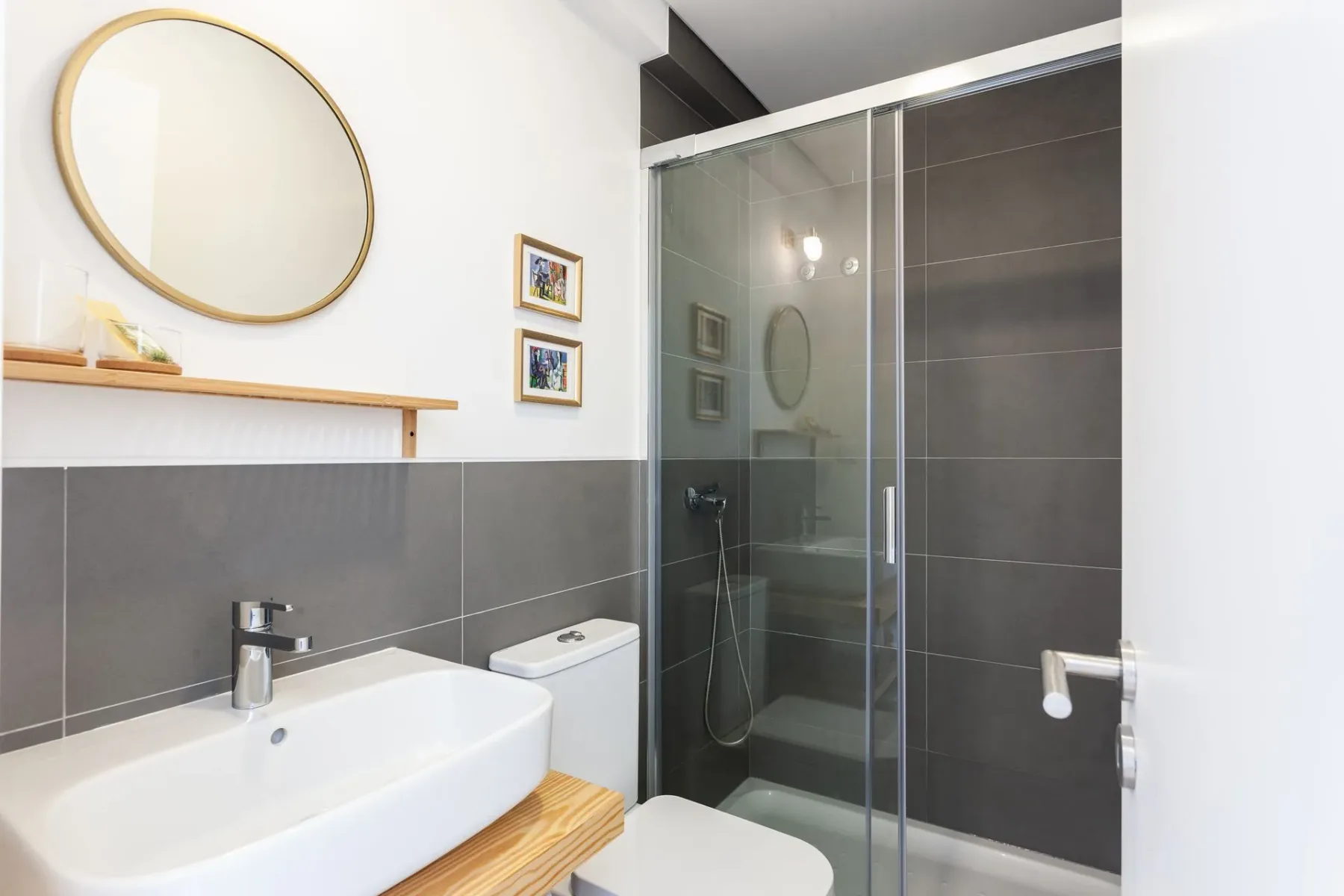Baño con lavabo, inodoro, espejo y cabina de ducha