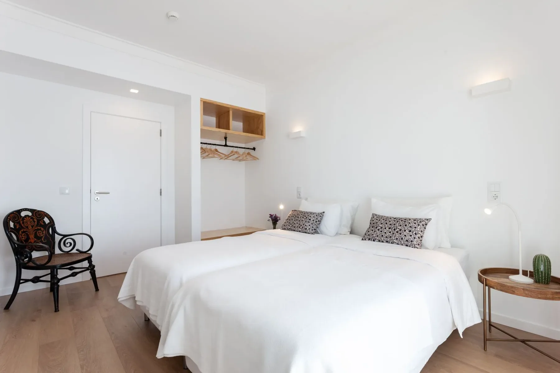 Dormitorio con dos camas, una silla y una mesa
