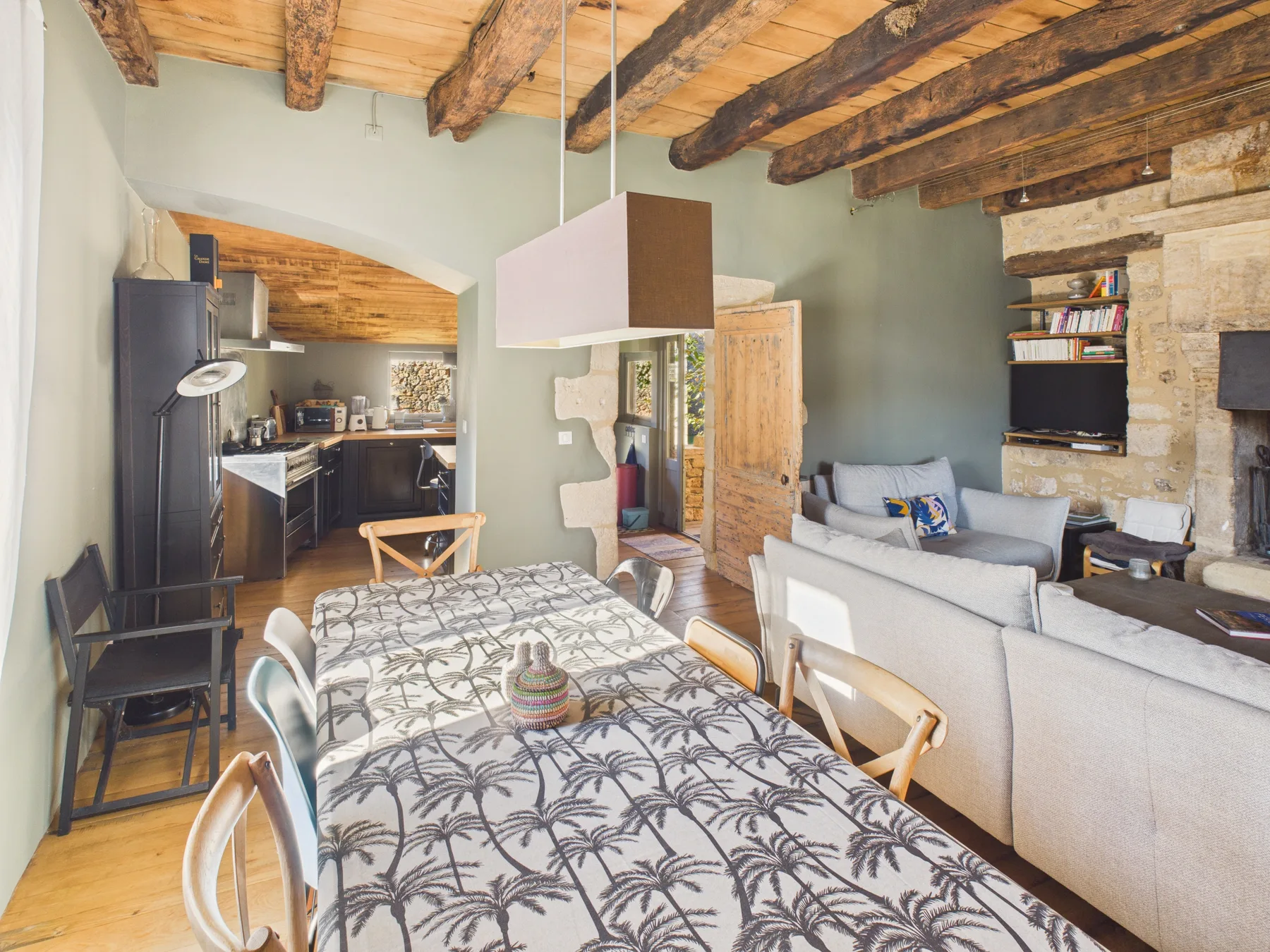 An open-plan living and dining area with a kitchen at the back.