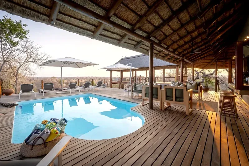 Swimming pool and lodge deck at sunset