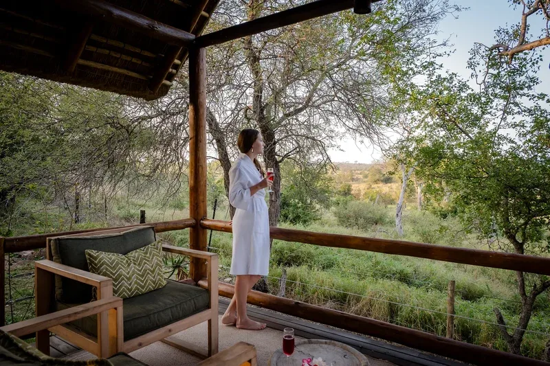 Guest relaxing on a private lodge balcony