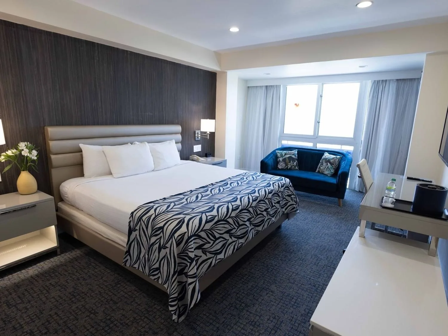 King bed and sofa in a Royal Deluxe Room.