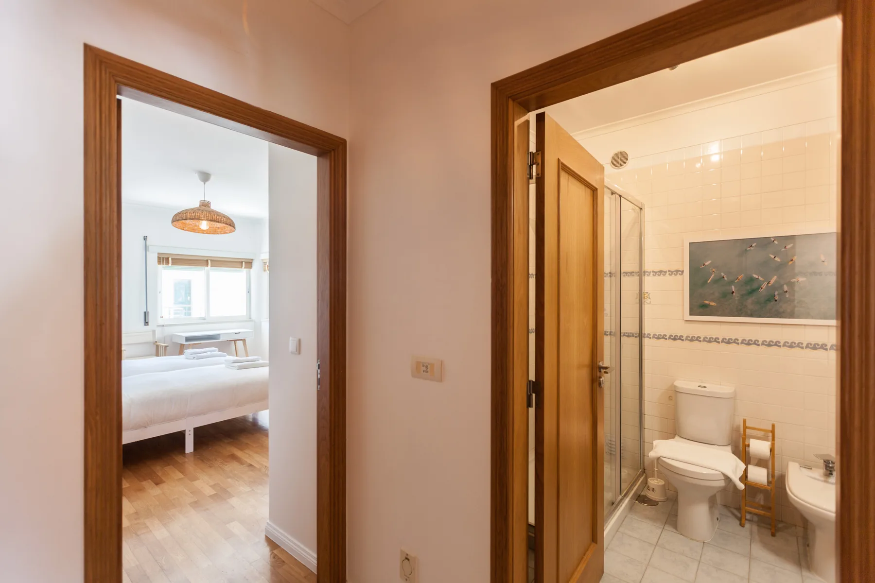 A bedroom and bathroom are visible through adjacent doorways.