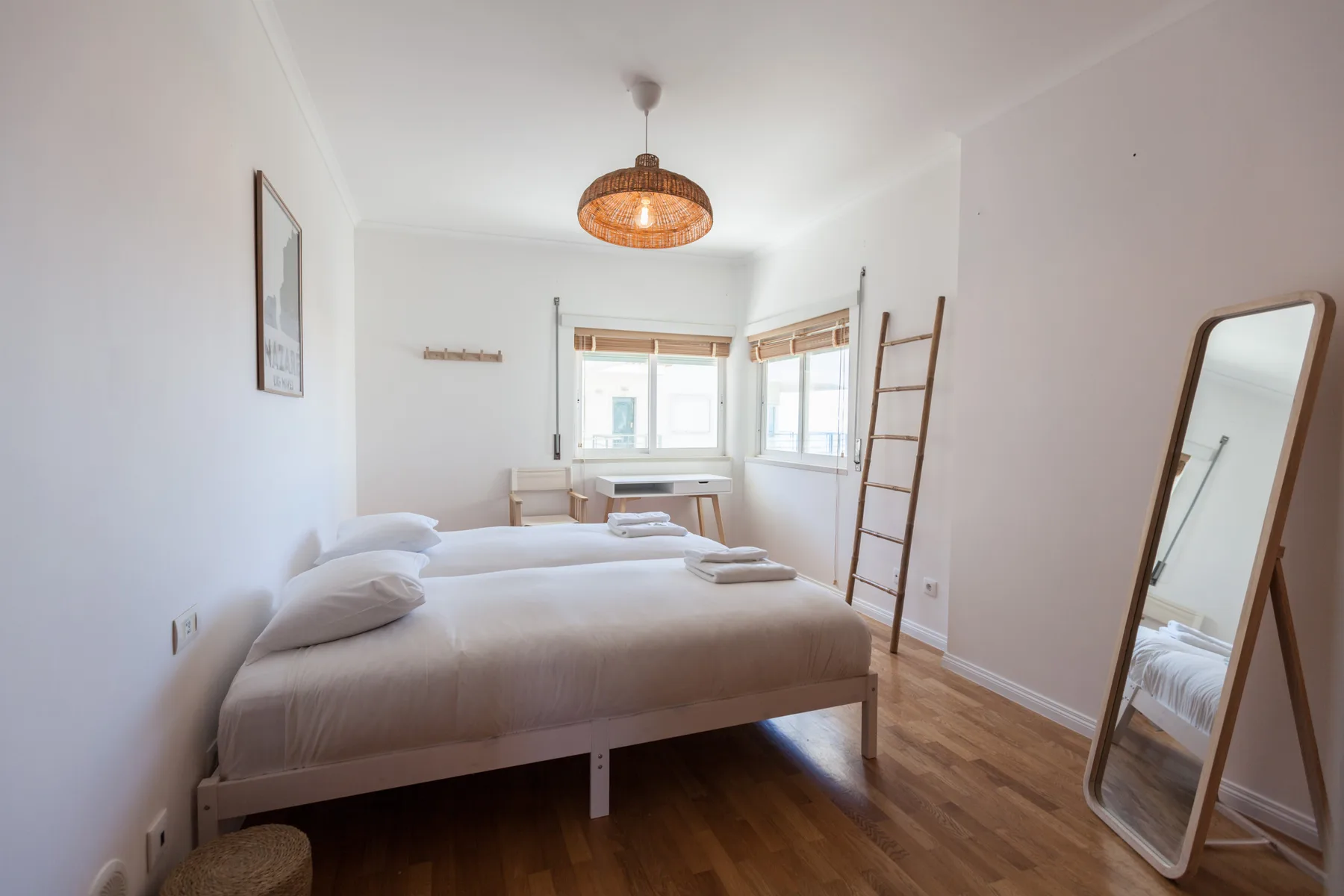 A bright bedroom with a bed and windows.