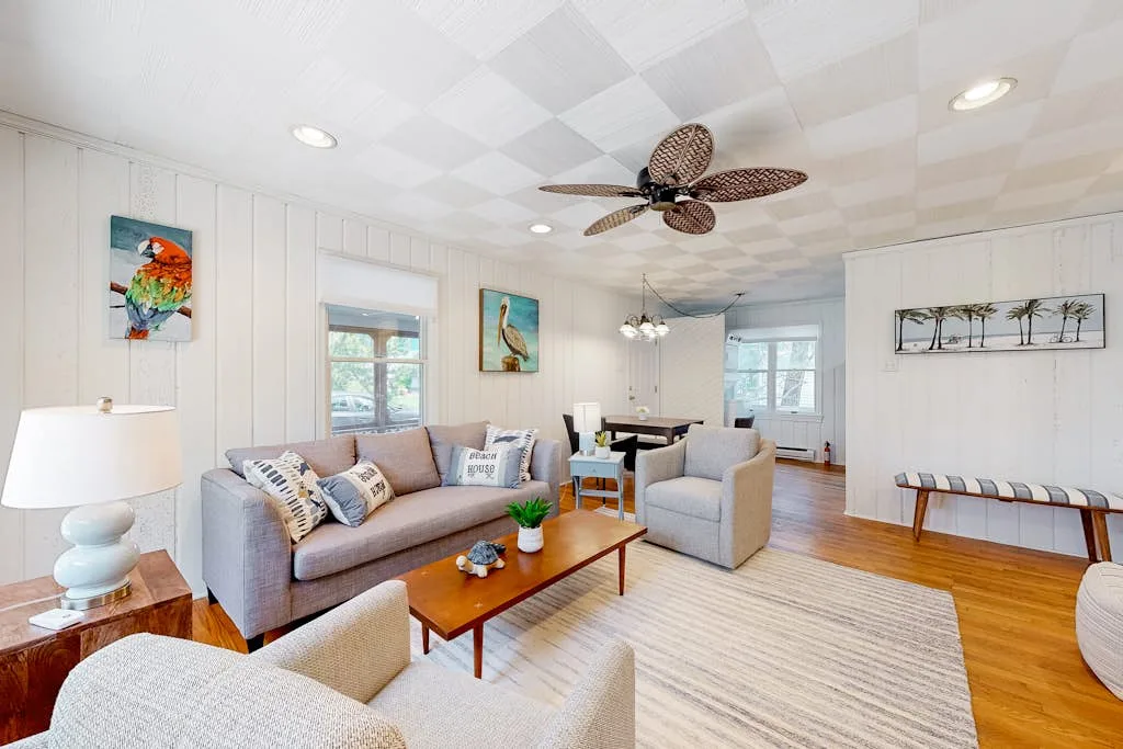 Bright living room with seating arranged around a wooden coffee table.