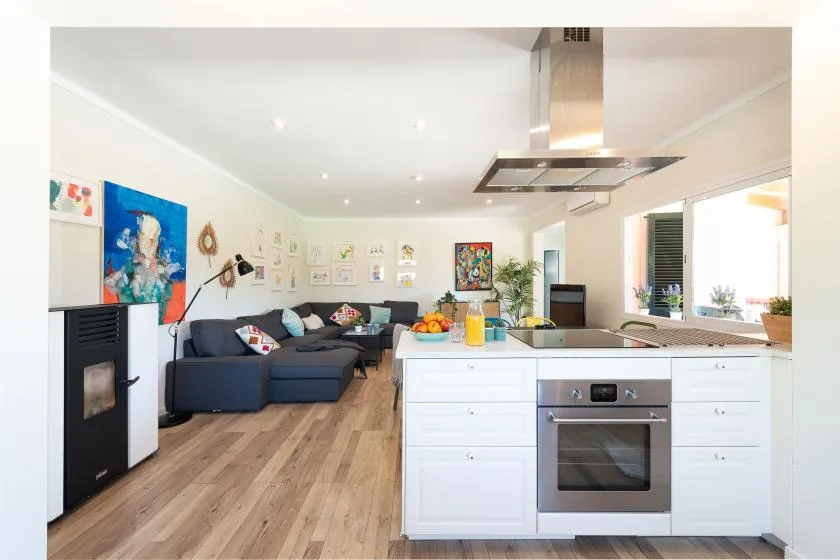 An open-plan kitchen and living area with an island and seating.