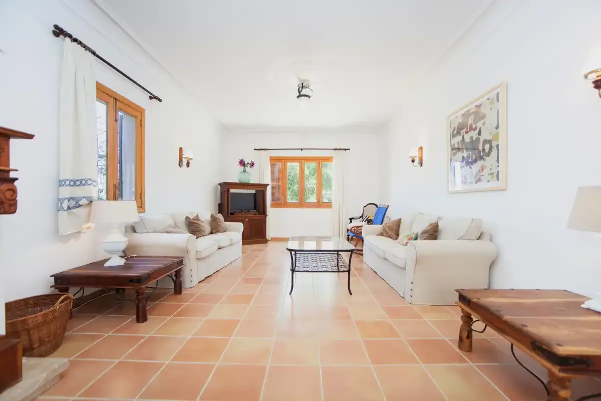 A bright living room with seating arranged around a low coffee table.