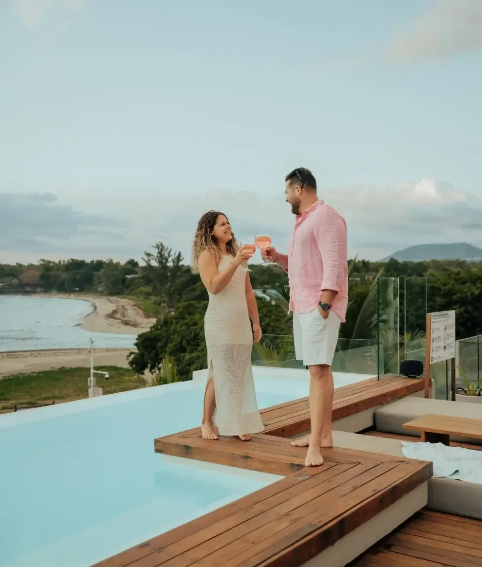 Guests at sunset by the pool