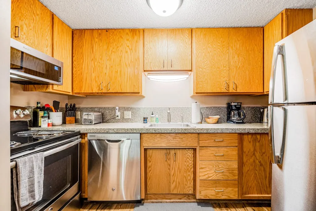 A kitchen with wooden cabinets, stainless steel appliances, and a countertop.
