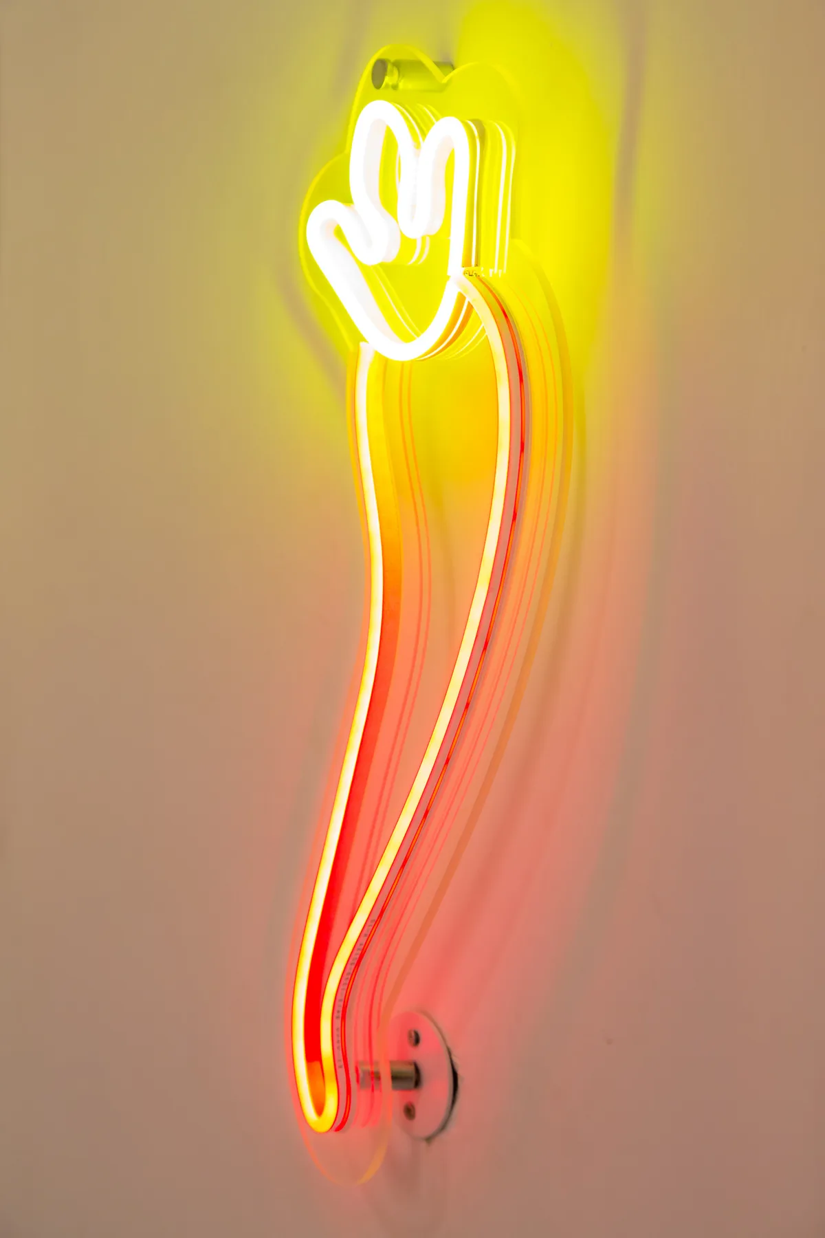 Una luz de neón brillante en la pared forma una figura abstracta.
