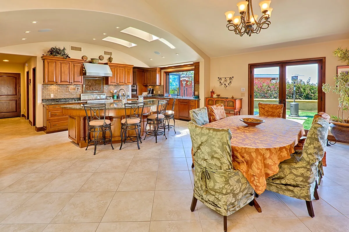 An open kitchen and dining area with a table beside the kitchen island.