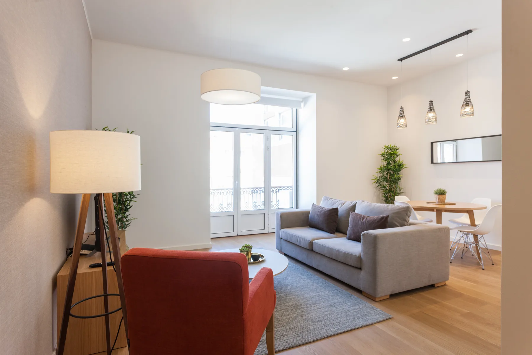 A bright living room with seating arranged around a coffee table.