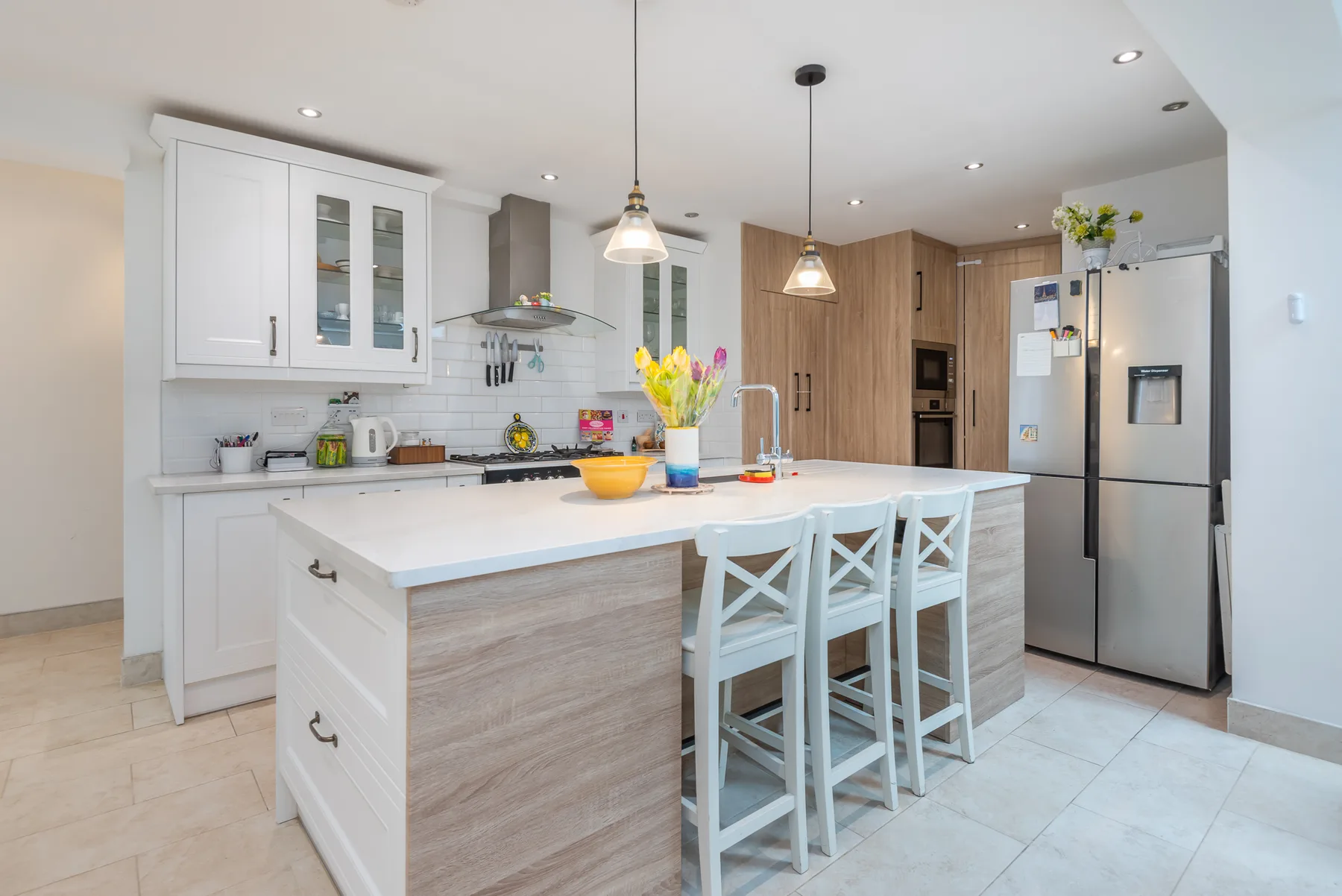 A bright kitchen with a large island and bar seating.