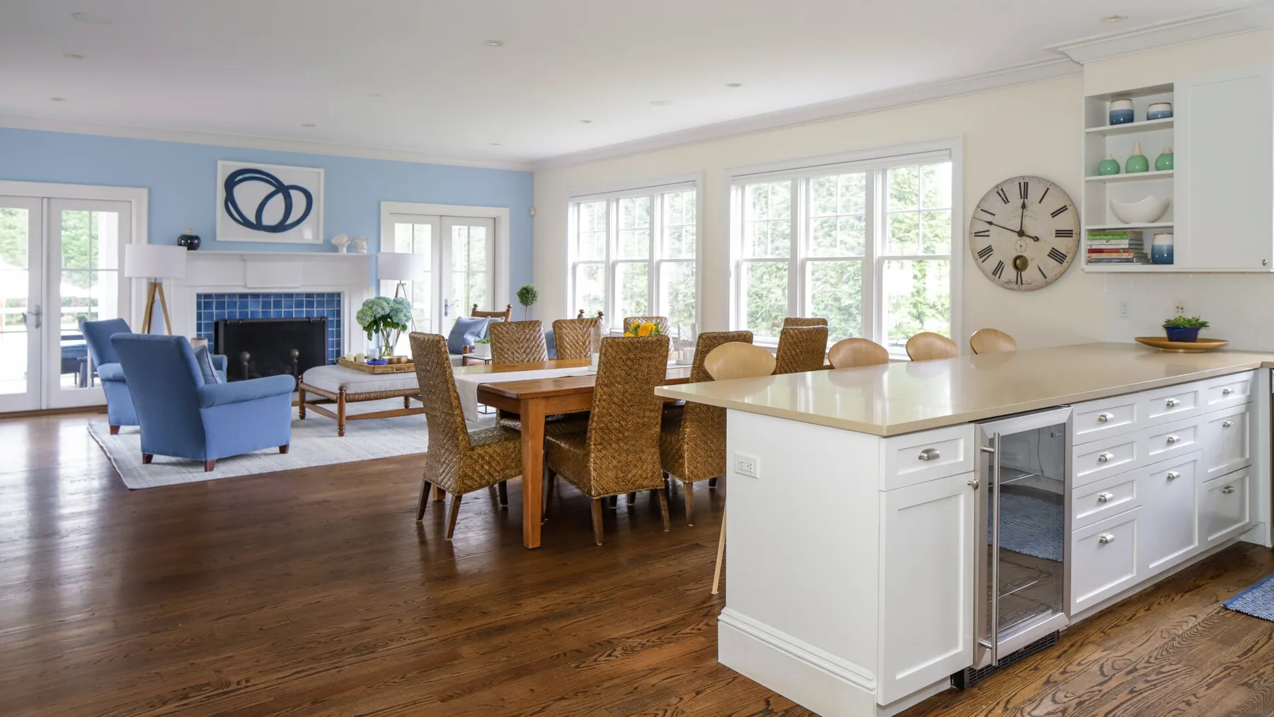 A bright open-plan kitchen and dining area with a large wooden table.