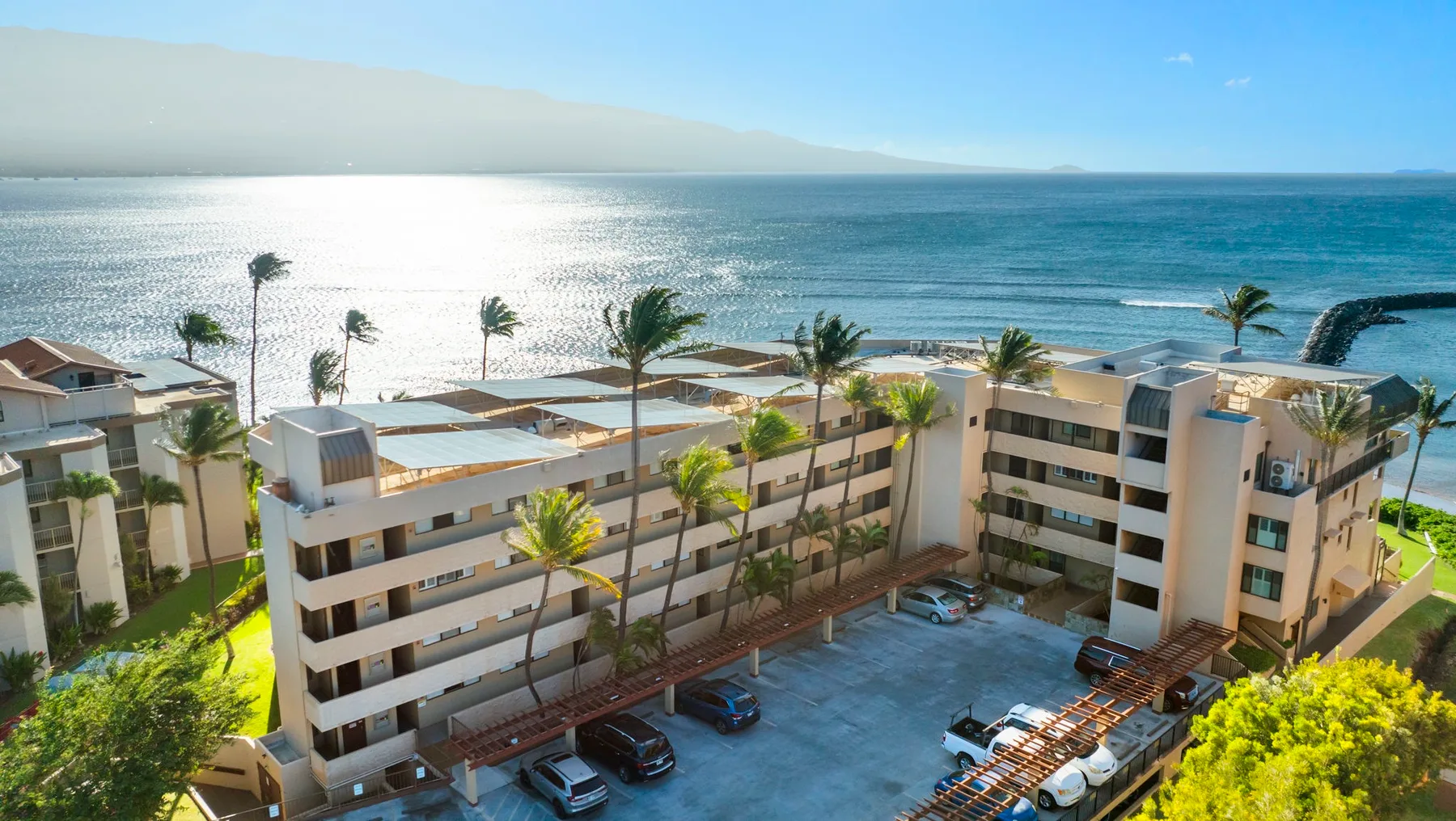 Aerial view of a beachfront hotel complex beside the ocean.
