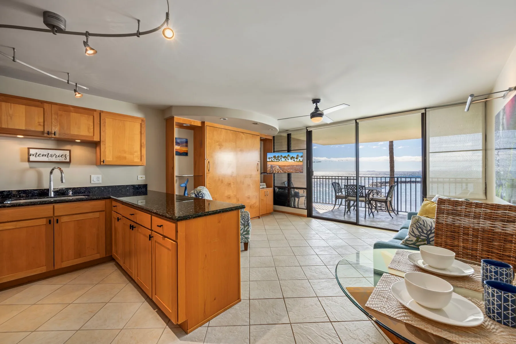 Open-plan kitchen and dining area with large windows overlooking a balcony.