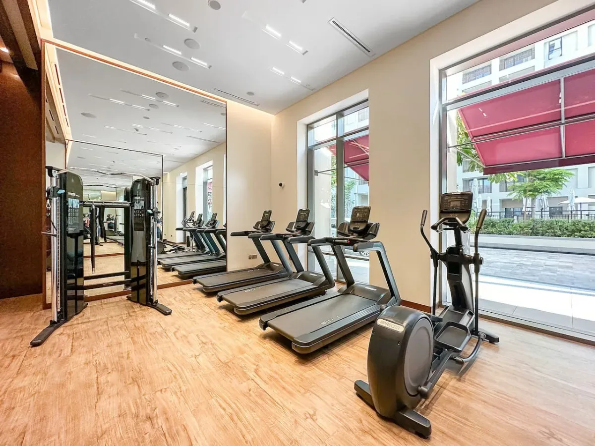 A fitness room with treadmills and other exercise equipment.