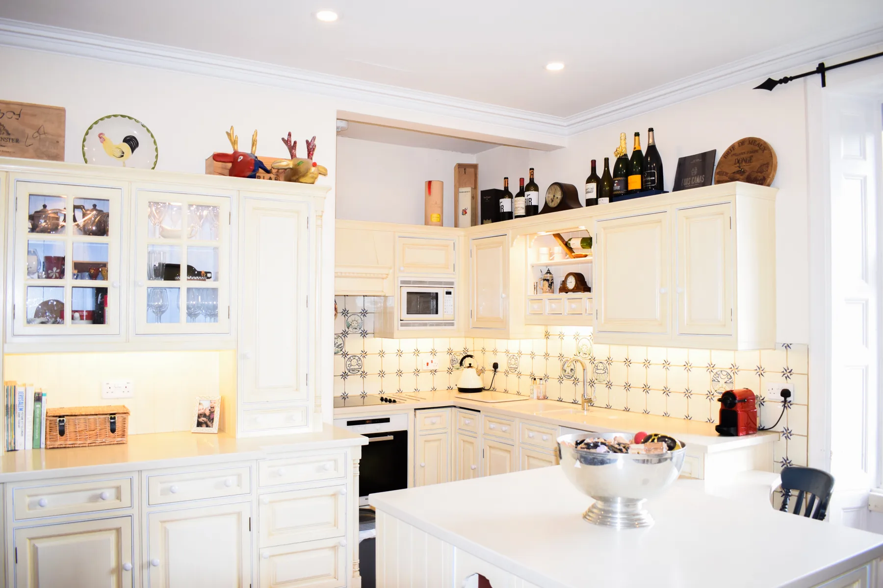 A bright kitchen with cream cabinetry and a central island.
