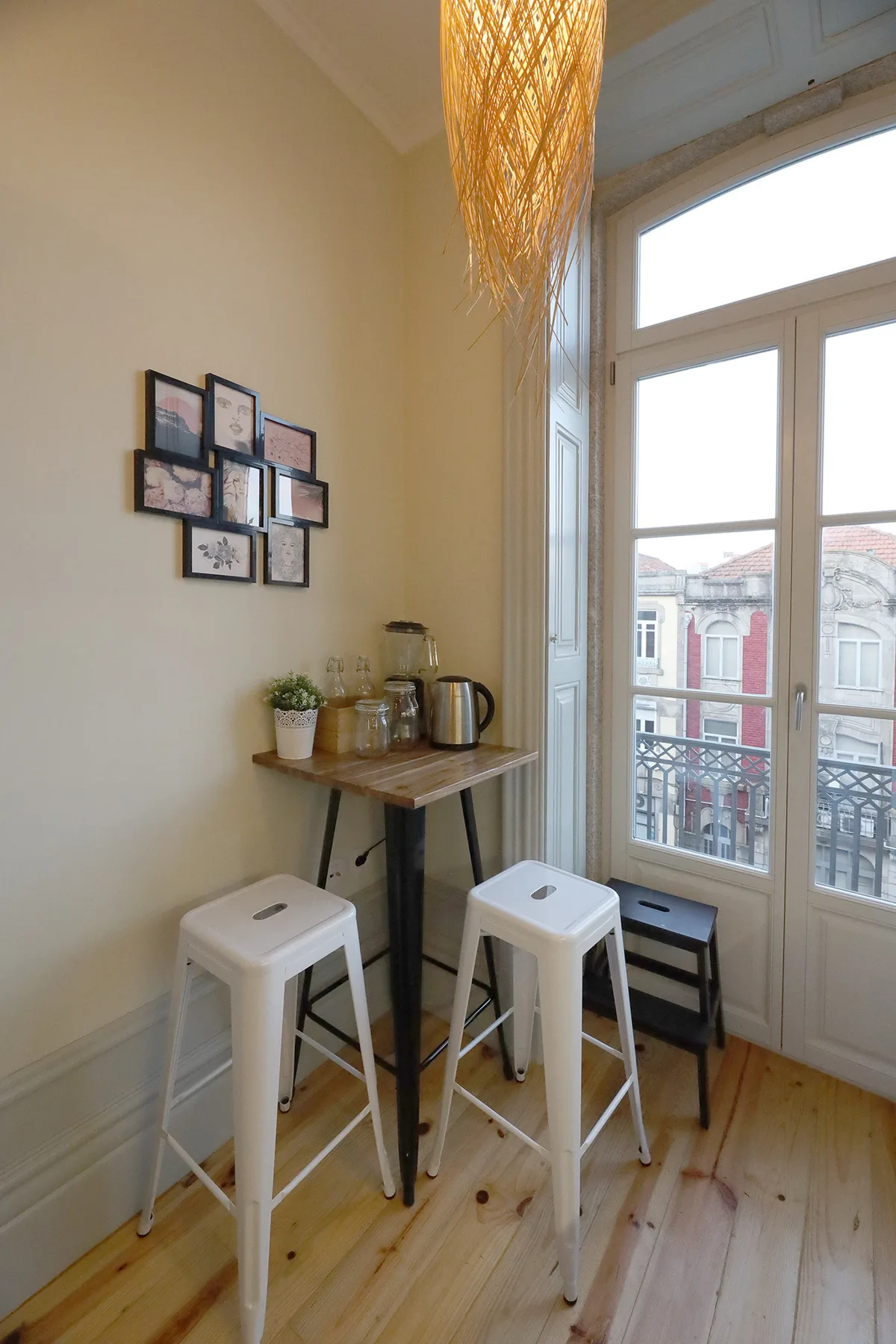 A bright dining nook with a wooden counter beside tall windows.