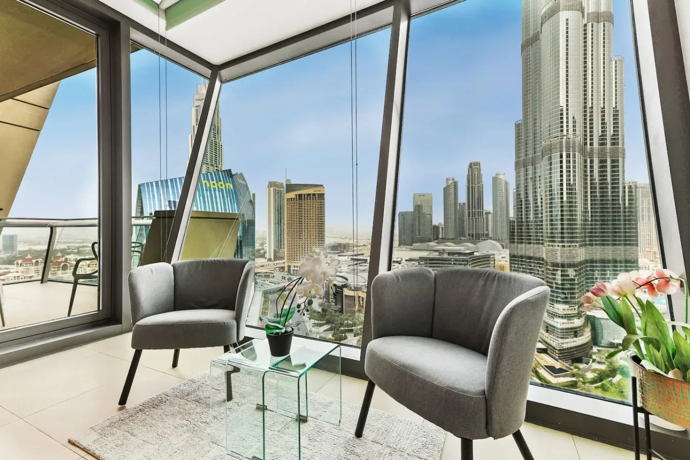 A bright window-side seating area overlooks a city skyline.