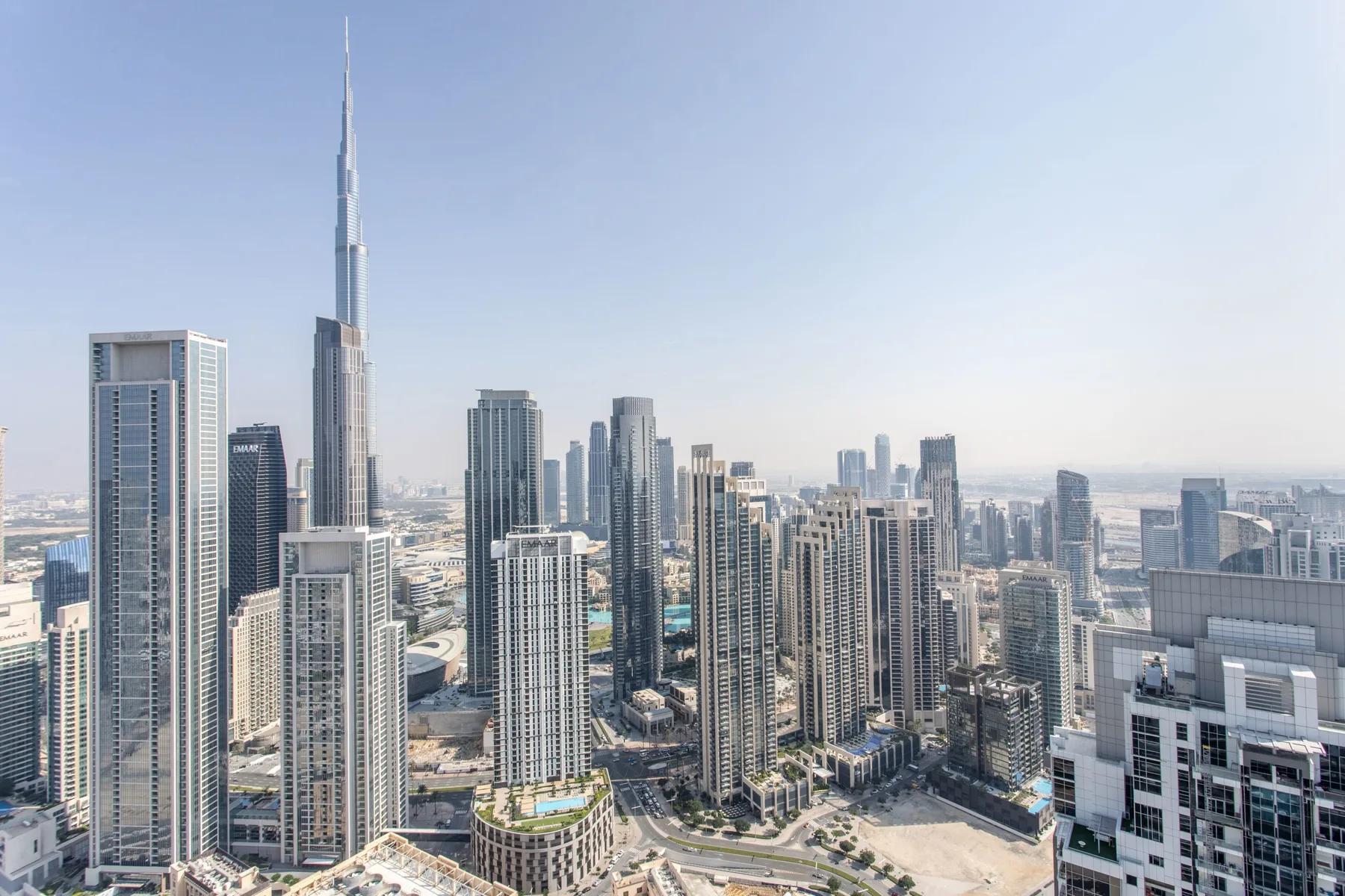 A city skyline with many high-rise buildings beneath a clear sky.