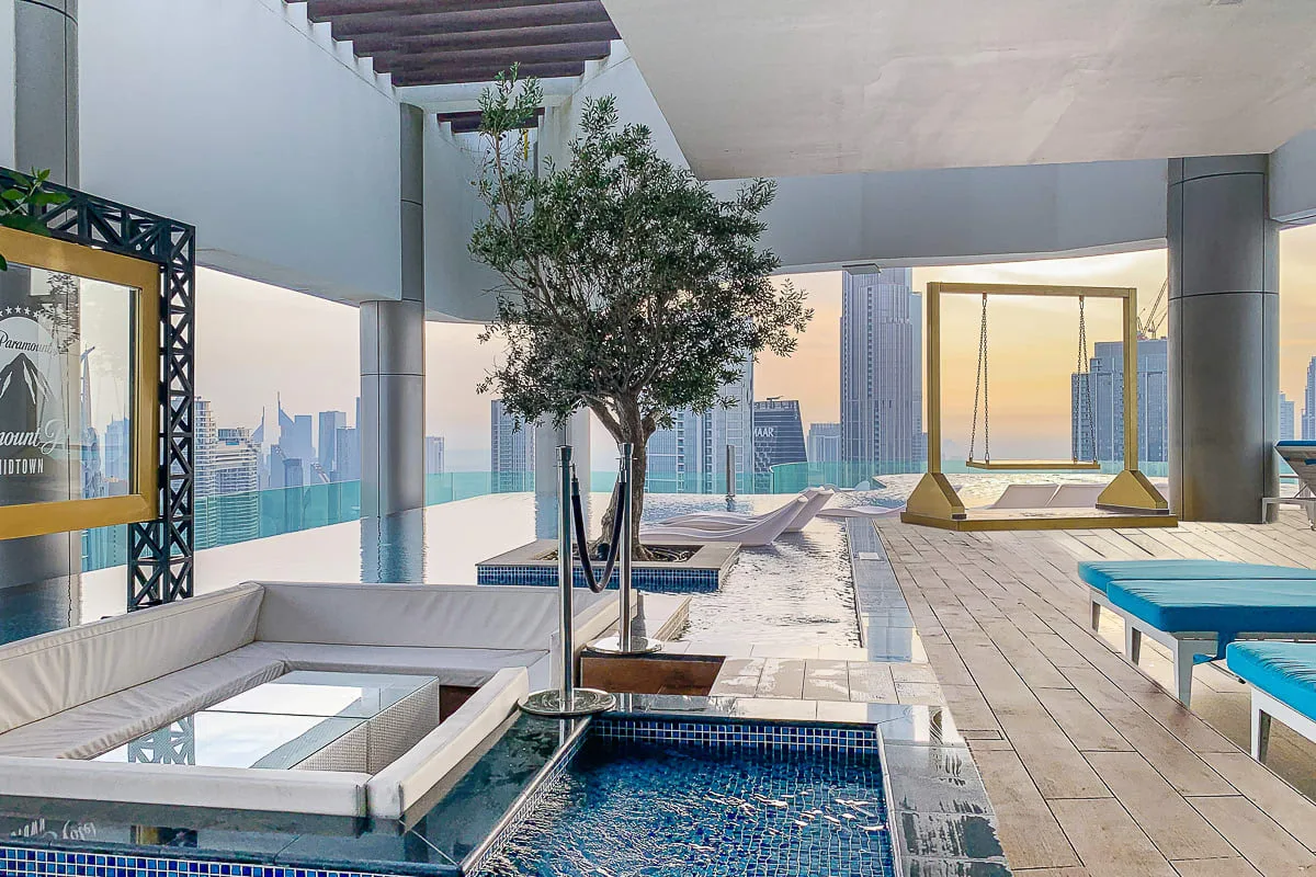 A rooftop terrace has lounge seating, a small pool, and city views.