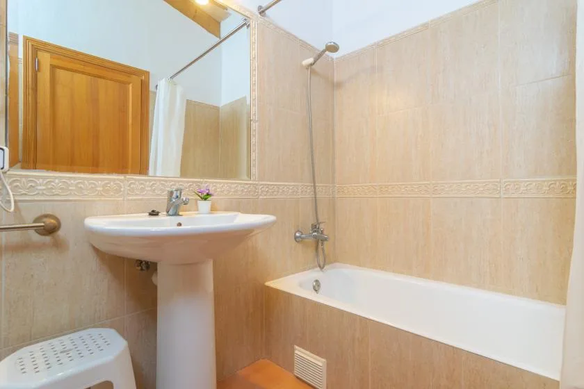 A bathroom with a sink beside a bathtub.