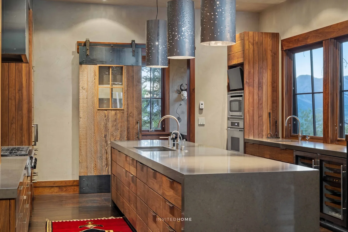 A spacious kitchen with a large island and wood cabinetry.
