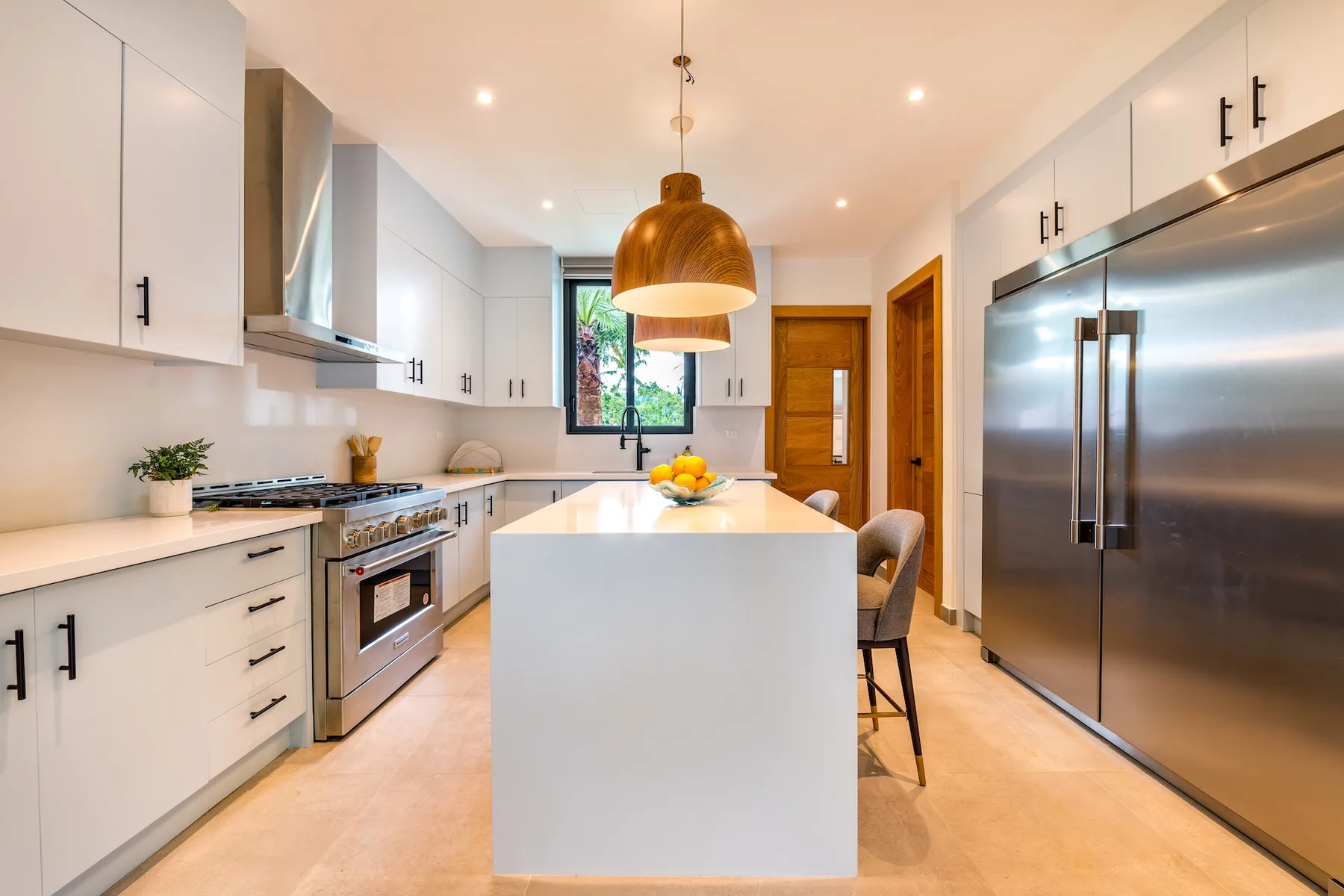 Una cocina moderna y luminosa con gabinetes blancos e isla central.