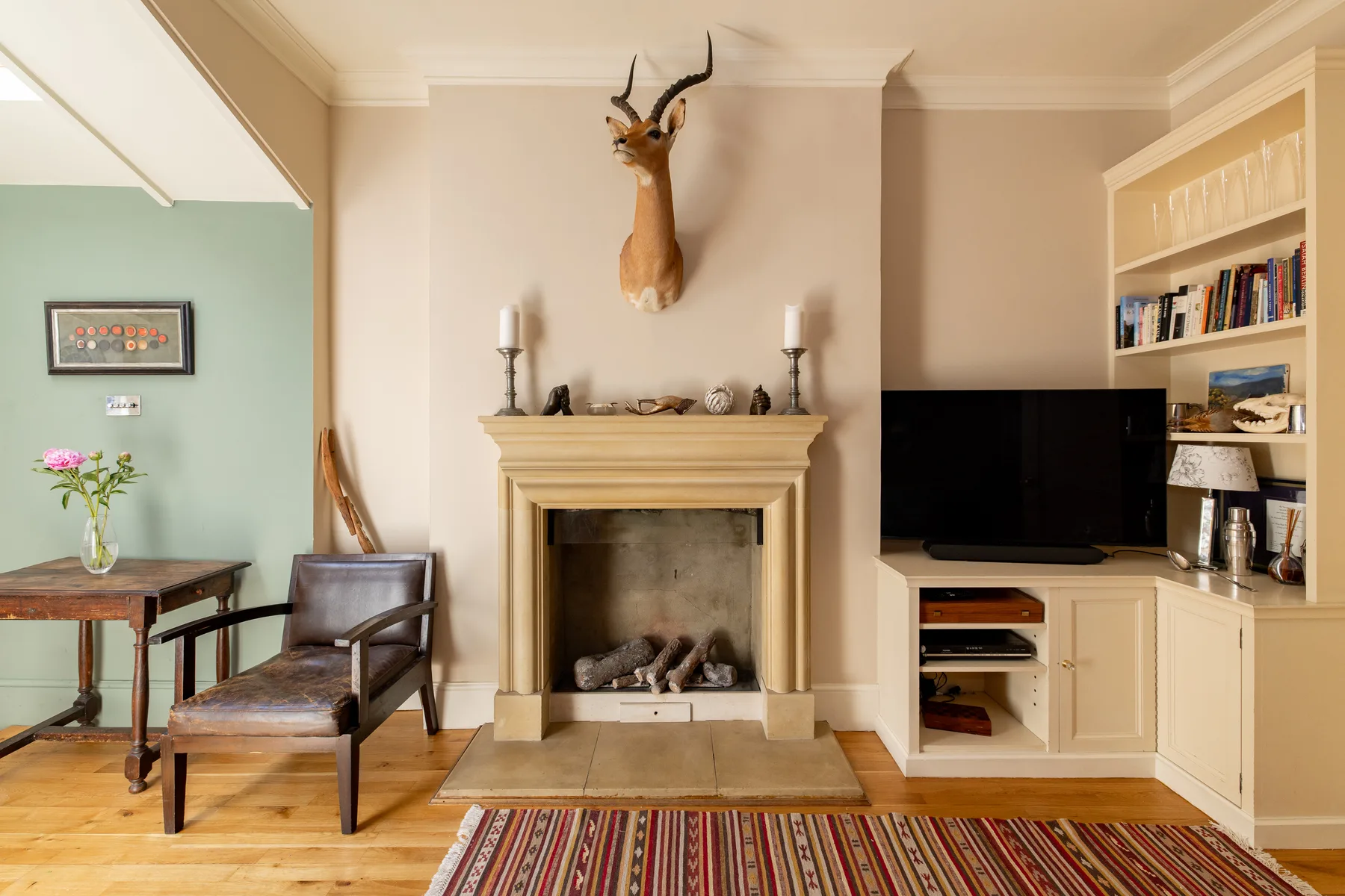 A living room with a fireplace, television, and seating.