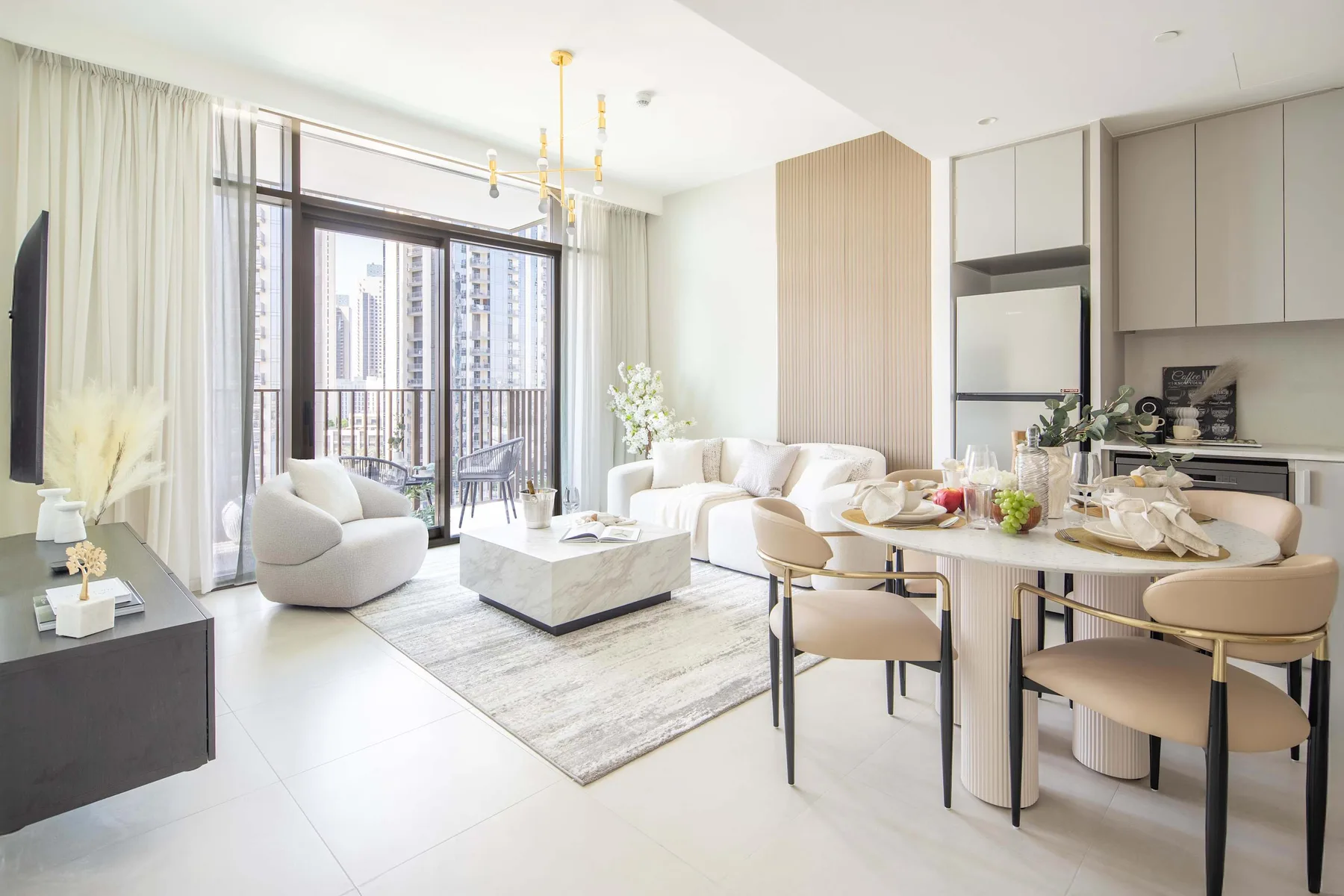 A bright open-plan living and dining area with large windows and a kitchen.