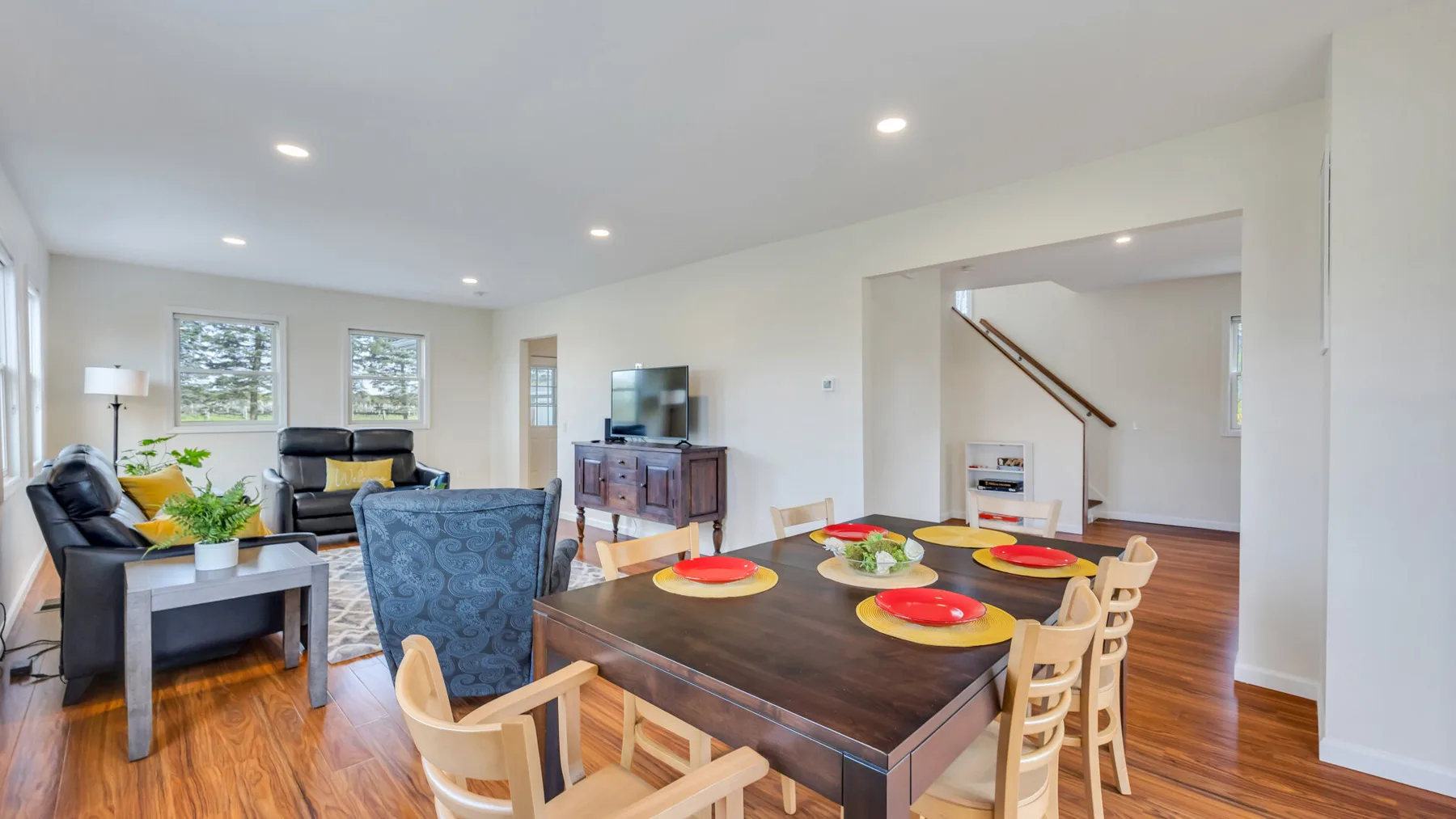 An open-plan living and dining room with a dining table and seating area.