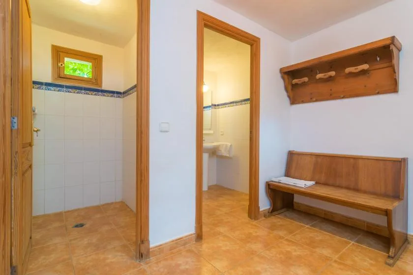 A tiled entry area with wooden doorways and a built-in bench.