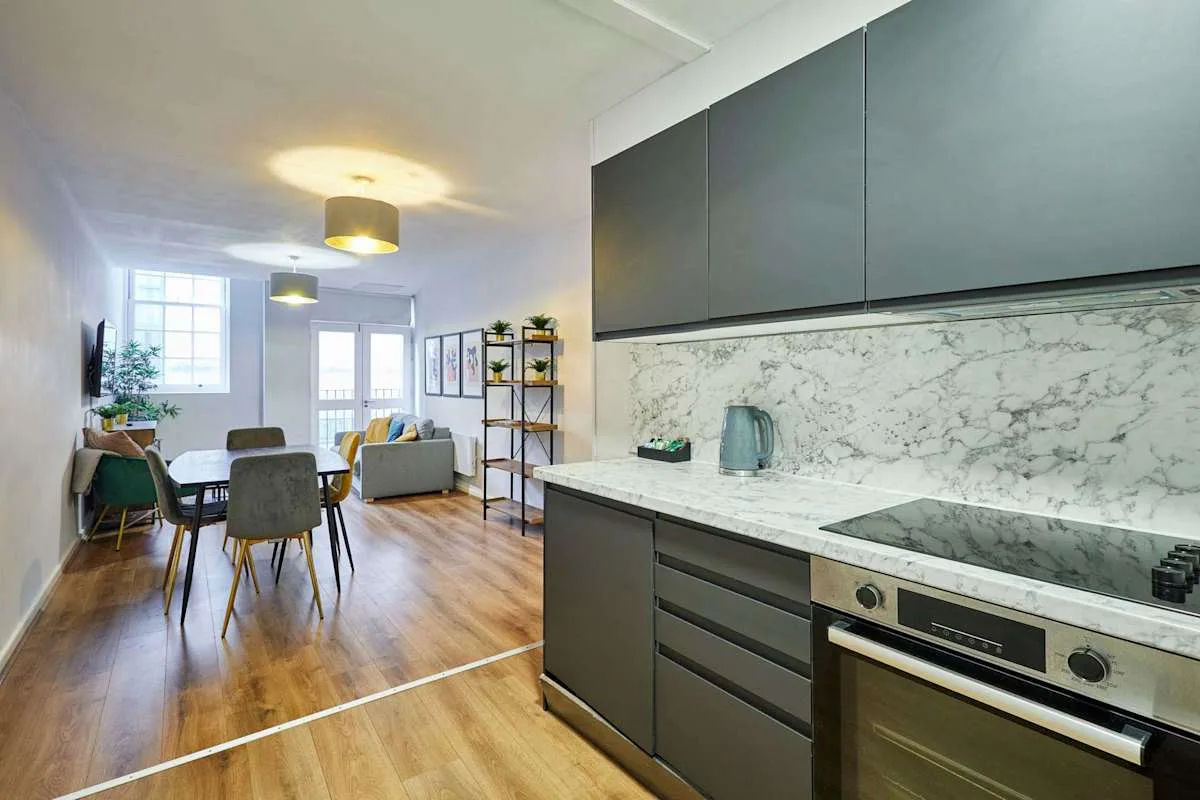 An open-plan kitchen and dining area with a living space beyond.